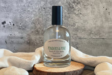 Load image into Gallery viewer, Room & Linen Spray bottle labeled 'Ponderosa Pine' on a wooden surface with a concrete wall background.