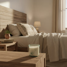 Load image into Gallery viewer, Candle in a glass jar with dandelion design on a wooden surface
